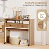 A desk with drawers and storage, set up in a room with decorative items and a door in the background. Produktbild-Vorschau