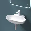 A white ceramic sink with a modern faucet mounted on a blue wall, with a lit mirror above. Produktbild-Vorschau