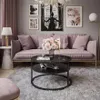 A living room scene with a pink couch, coffee table, and decor. Produktbild-Vorschau