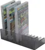 A black plastic storage rack holding several Nintendo Switch game cases. Produktbild-Vorschau