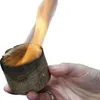 A hand holding a burning fire starter. Produktbild-Vorschau