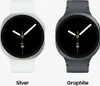Two smartwatches, one silver and one graphite, are displayed side-by-side against a white background. Produktbild-Vorschau