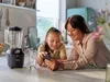 A woman and a child looking at a smartphone in a kitchen setting. Náhľad obrázku produktu