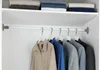 A closet interior with a telescopic tension rod holding several garments. Produktbild-Vorschau