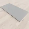 A flat, gray shower tray is placed on a light wood-look floor. Produktbild-Vorschau
