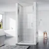 A modern bathroom with a white bathtub and a glass shower enclosure. Podgląd zdjęcia produktu
