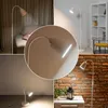 Collage of images showing a white floor lamp in different settings and close-ups. Anteprima dell’immagine prodotto