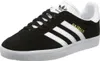 A black Adidas Gazelle sneaker with white stripes and gold lettering. Náhled obrázku produktu