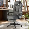 A gaming chair is shown in a home office setting with a desk, computer, and window in the background.
