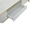A close-up view of an open drawer on a white TV cabinet with a marble-like top and gold trim. Podgląd zdjęcia produktu