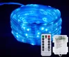 A coiled string of blue LED lights with a remote control and battery pack. Produktbild-Vorschau
