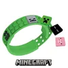 A green Minecraft-themed bracelet with detachable pixelated charms. Produktbild-Vorschau