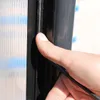 A close-up shot of a person's thumb pressing on a black rubber seal, likely for a greenhouse. Produktbild-Vorschau