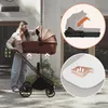 A woman is shown attaching a bassinet to a stroller outdoors. Voir les images du produit