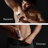 A man is shown using a body groomer on his underarm and groin area, with text indicating 'Rasieren' (Shave) and 'Trimmen' (Trim). Náhľad obrázku produktu