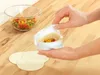 A person is preparing a taco using a special tool. Produktbild-Vorschau
