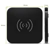 A black square wireless charger with dimensions indicated by measurement lines and text. Produktbild-Vorschau