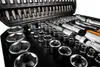 A close-up view of a black toolbox filled with various metal tools, including sockets, wrenches, and screwdriver bits. Anteprima dell’immagine prodotto