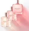 Three bottles of Givenchy Irresistible Rose Velvet Eau de Parfum are arranged diagonally on a white background, with soft pink lighting and shadows. Voir les images du produit