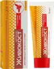 A product shot of a cream-balm tube and its box, both featuring yellow and orange checkered patterns and red accents. Produktbild-Vorschau