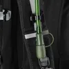 A close-up view of a green hydration tube attached to a black backpack. Anteprima dell’immagine prodotto