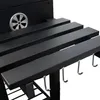 A close-up view of the side of a black grill, focusing on the slatted shelves and hooks. Podgląd zdjęcia produktu