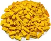 A pile of yellow LEGO bricks on a white surface. Produktbild-Vorschau