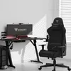 A gaming desk and chair setup in a room with blinds casting shadows. Náhled obrázku produktu