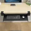 A keyboard tray is mounted under a desk, holding a keyboard and mouse. Produktbild-Vorschau