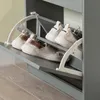 A close-up view of a gray shoe cabinet with three open flip-out drawers, each holding a pair of shoes. Podgląd zdjęcia produktu