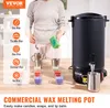 A person is demonstrating how to use a commercial wax melting pot to make candles. Podgląd zdjęcia produktu