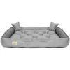 A grey dog bed with tufted cushioning and raised sides, presented on a white background. Náhled obrázku produktu