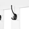 A close-up view of a black coat hook attached to a white panel. Produktbild-Vorschau