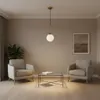 A modern living room scene with two armchairs, a glass coffee table, and a pendant light. Produktbild-Vorschau