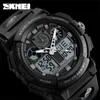 A close-up studio shot of a black digital watch against a black background. Produktbild-Vorschau