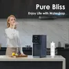 A woman drinks water from a glass in a modern kitchen, next to a water dispenser and a filter. Voir les images du produit