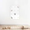 A minimalist climbing wall for children mounted on a white wall above a wooden floor with some wooden toys. Anteprima dell’immagine prodotto