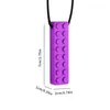 A purple teething necklace shaped like a Lego brick, with dimensions indicated. Produktbild-Vorschau