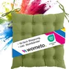 A green seat cushion with a colorful powder explosion in the background. Náhled obrázku produktu