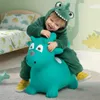 A child in a dinosaur costume is happily bouncing on a green inflatable toy in a bedroom. Podgląd zdjęcia produktu