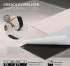 A close-up demonstration of how to install self-adhesive vinyl flooring panels, showing the peeling of the backing and the application process. Podgląd zdjęcia produktu