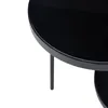 A close-up of a black, round table with a glass top and metal legs. Anteprima dell’immagine prodotto
