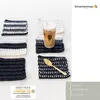 Crocheted coasters with a drink and spoon. Produktbild-Vorschau