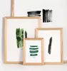 Several framed art prints with abstract brushstroke designs are arranged on a white surface. Produktbild-Vorschau