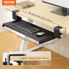 A black keyboard tray is clamped to the underside of a light-colored desk, with a keyboard and mouse on it. Dimensions are shown with measurement lines and text. Produktbild-Vorschau