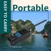 A handheld radio is shown in the foreground with a scenic background of islands and water. Náhled obrázku produktu