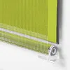 A close-up view of a green roller blind with a silver stripe, showing the mechanism at the bottom. Produktbild-Vorschau
