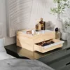 A wooden jewelry box with a glass top sits on a dark dresser next to perfume bottles and a vase with greenery. Voir les images du produit