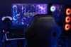 A gaming setup with a chair, monitor, and computer tower. Produktbild-Vorschau