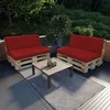 Outdoor patio furniture set with red cushions on wooden pallet bases, a coffee table, and a rug. Voir les images du produit